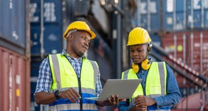 african-workers-engineer-technician-holding-laptop-checking-inspecting-site-containers_28976-1877